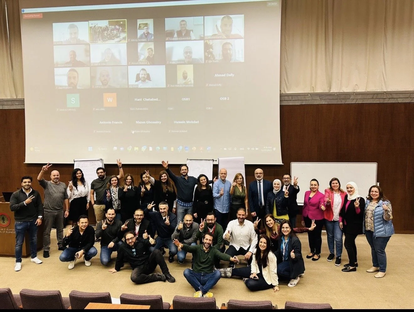 A large group of people posing for a photo in a conference room.